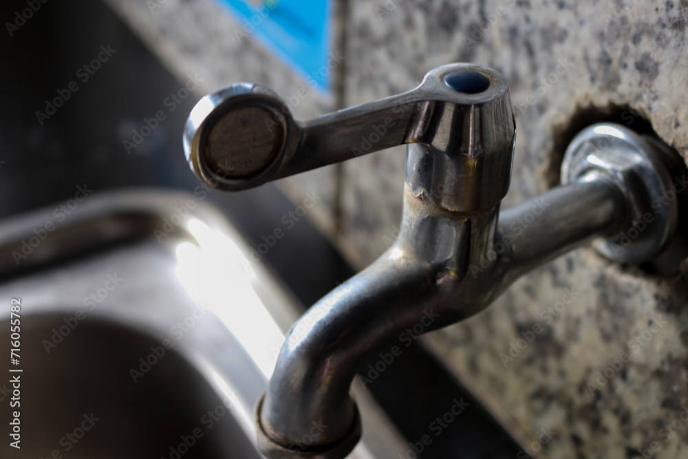 Photo of a faucet in a bathroom in a hotel or house