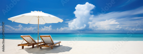 Sunbeds and umbrella on the beach, summer vacation background