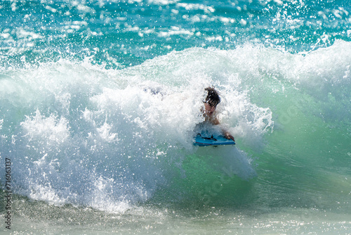boogie boarding and playing in the water at Poipu beach © Allison