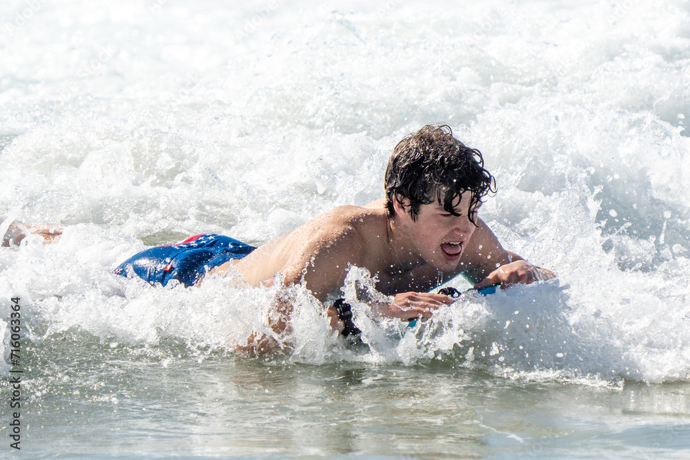 boogie boarding and playing in the water at Poipu beach