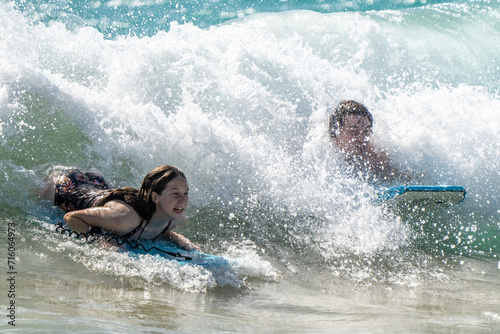 surfing on the beach in hawaii  © Allison