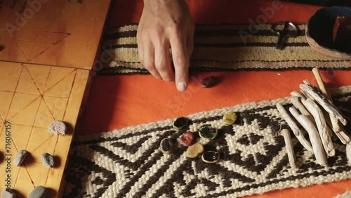 Traditional mapuche recreational games. Closeup view of a man playing Auarr-cuden mapuche game, similar to payana. He throws sliced beans.