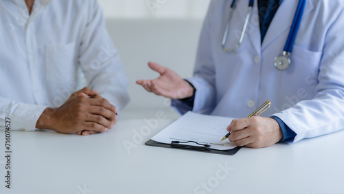Doctor Consulting with Patient in Clinic.
