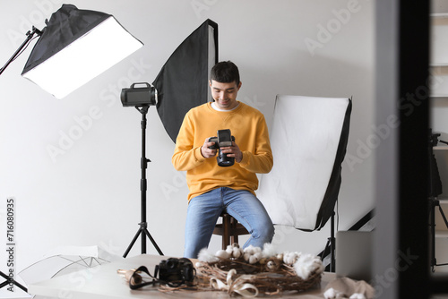 Young male photographer wit...
