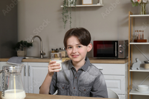 Smiling young boy holding g...