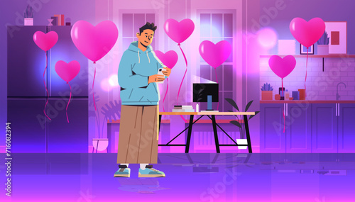 young man in love using smartphone social media communication valentines day celebration concept living room interior