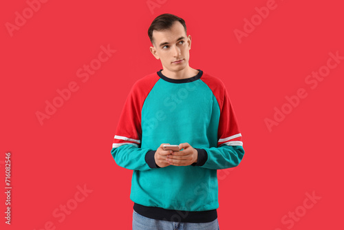 Young man with mobile phone...