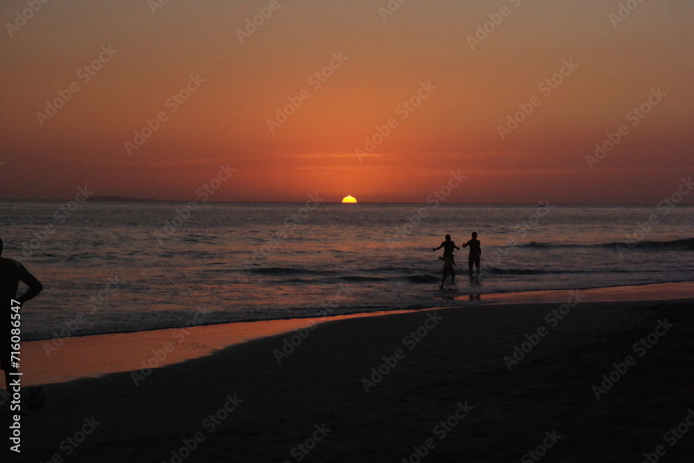 silhouette of a couple walking on the beach