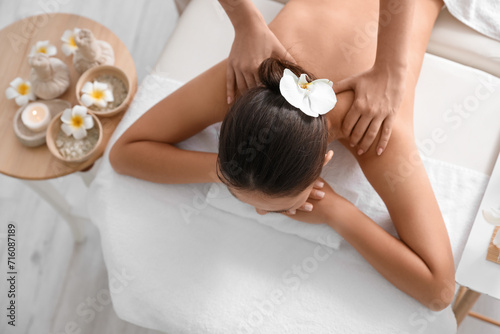 Young woman having massage in spa salon, top view