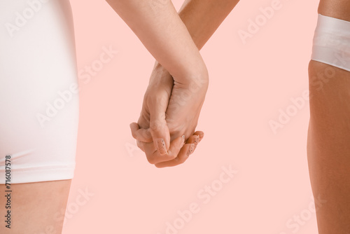 Body positive women on pink background, closeup