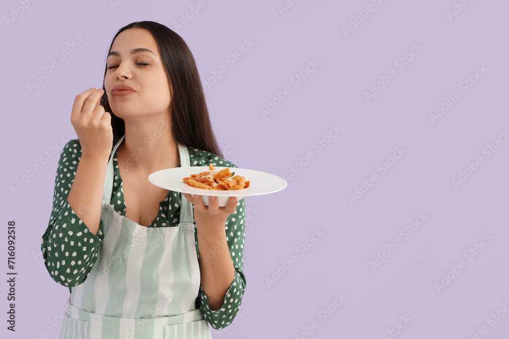Young woman with tasty pasta on lilac background Young woman with tasty pasta on lilac background