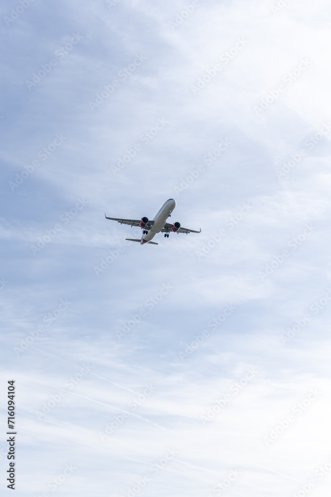 Fuselage of a passenger plane in a beautiful blue sky descending towards the runway of Madrid airport Fuselage of a passenger plane in a beautiful blue sky descending towards the runway of Madrid airport
