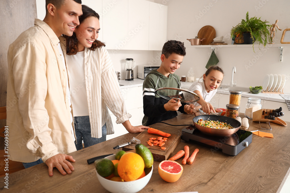 Happy family cooking in kitchen Happy family cooking in kitchen
