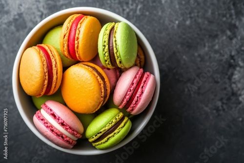 Colorful macaroons in a bowl a French sweet dessert seen from above