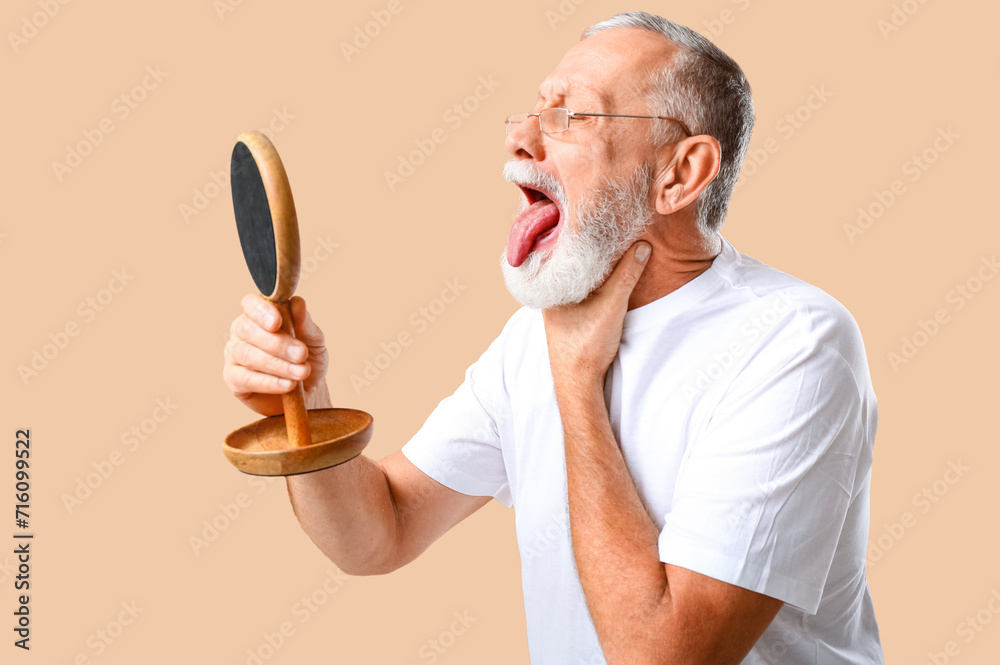 Ill old man with sore throat on beige background Ill old man with sore throat on beige background
