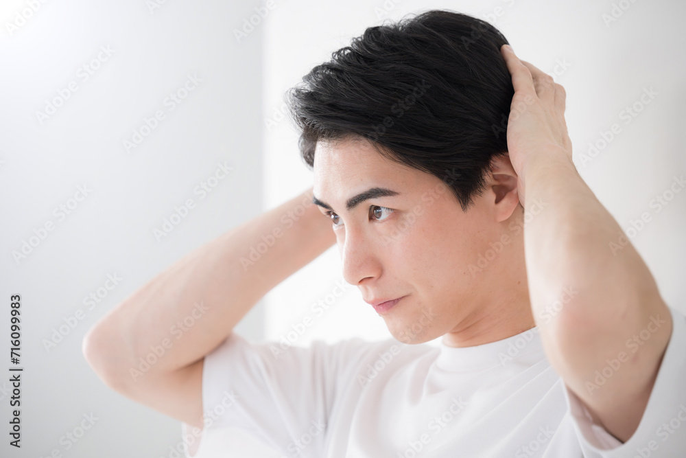 Man touching hairline Close-up Checking in mirror Man touching hairline Close-up Checking in mirror