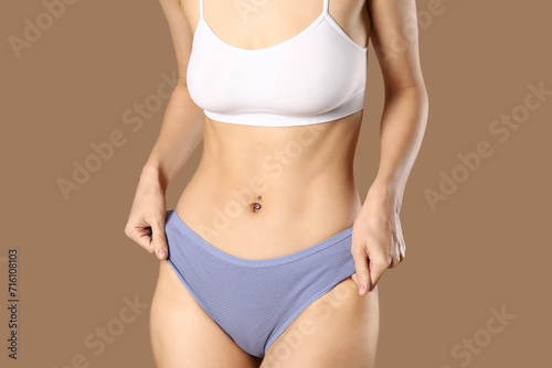 Young woman in panties on b...