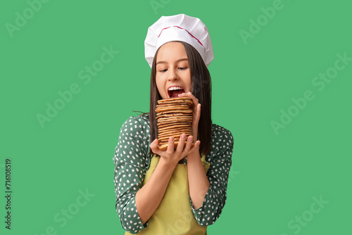 Young female chef eating ta...