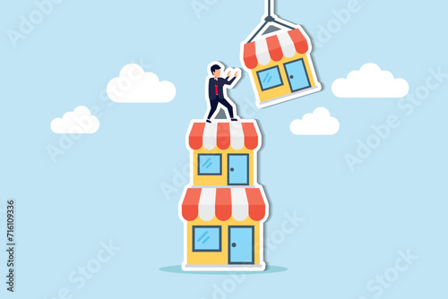Build up business, expand or growing company empire, organization growth or ambition and effort to improve sales, extension concept, ambitious businessman build up store on top of company stack.
