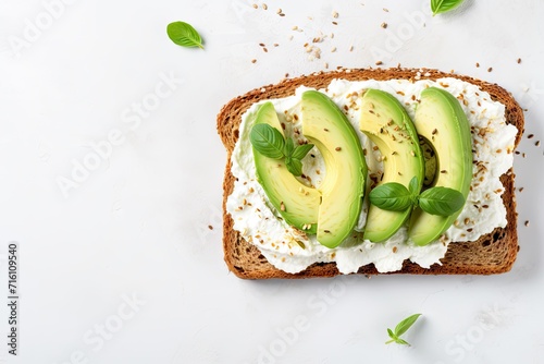 Healthy avocado open sandwich on white stone table