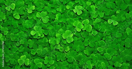Green shamrock background. Top view with copy space. For design, flyer, postcard. The concept of St. Patrick's Day is associated with either Irish culture or the myths of leprechauns. photo