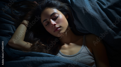 Young woman sleeping in her bed