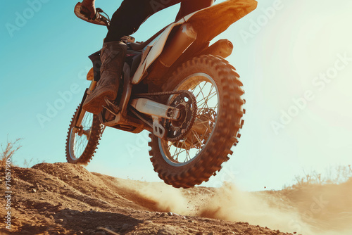 closeup Motorcycle jump, sports outdoor with exercise in desert, stunt for extreme sport