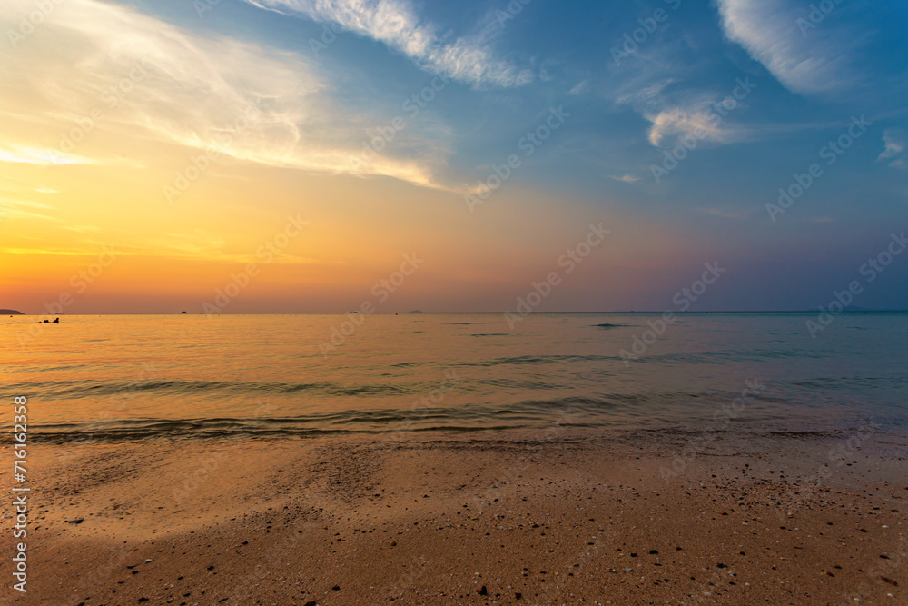 Beautiful summer beach and sea and yellow orange sky at the sunset, twilight period which including of sunrise