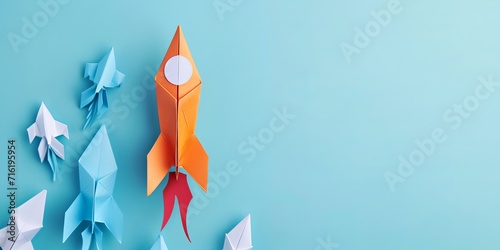 leadership success business concept rocket paper fly over color background lead rocket stand out of other paper rocket follower photo