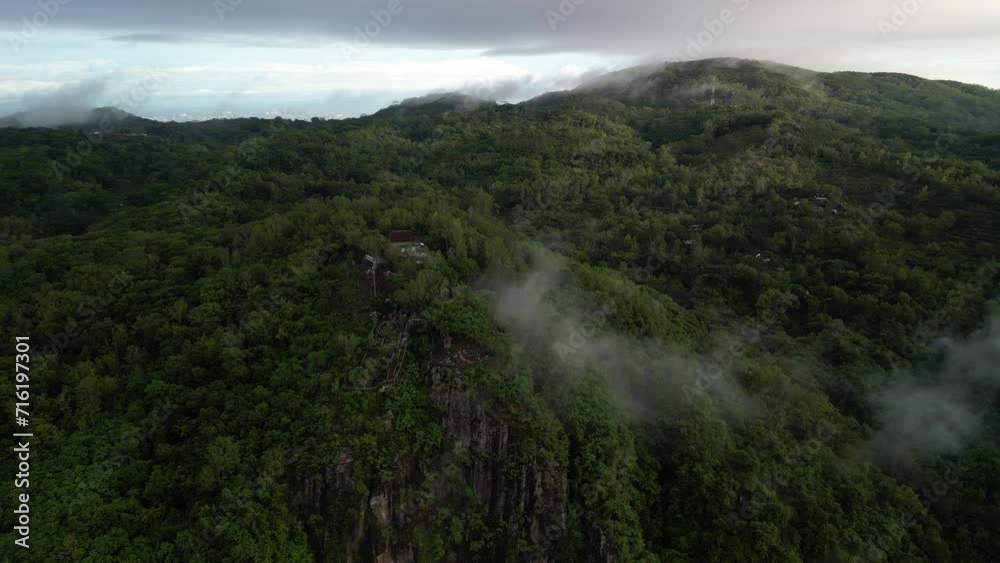 4k Aerial view of Dense natural forest trees on the mountain hills with morning mist. Misty and Foggy Jungle. Concept for International Day of Forest, World Environment Day, Asian Rainforest. 4k Aerial view of Dense natural forest trees on the mountain hills with morning mist. Misty and Foggy Jungle. Concept for International Day of Forest, World Environment Day, Asian Rainforest.