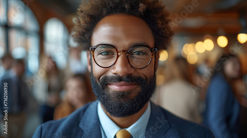 Close-up view of a smiling and confident African American male business executive - CEO - Professor - Office worker - blurred background - motivated black professional 