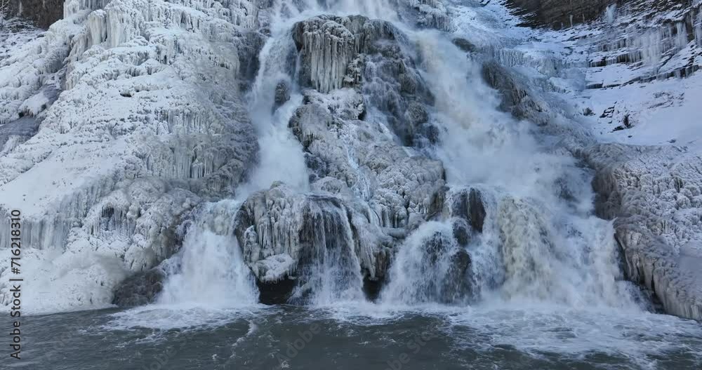 Afternoon winter aerial video of frozen Ithaca Falls on Fall Creek, City of Ithaca, NY, USA 01-21-2024