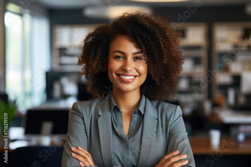 Smiling woman confidently stands with her arms crossed. Perfect for showing professionalism and confidence