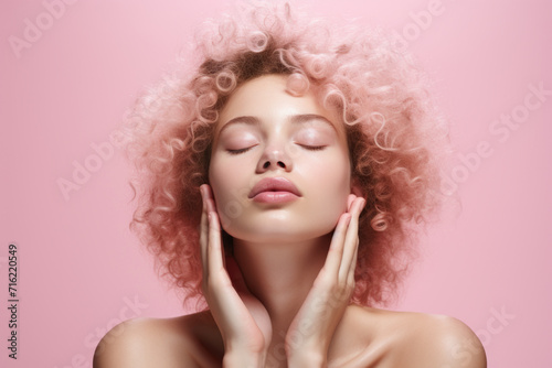 Woman with vibrant pink hair posing for camera with her eyes closed. This image can be used to convey relaxation, mindfulness, or self-expression