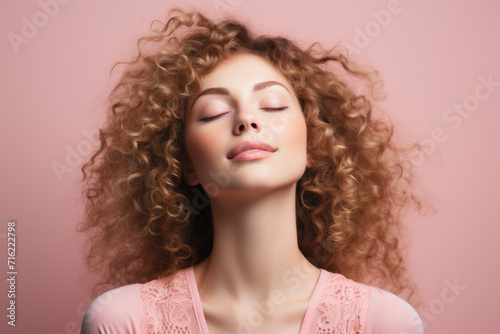 Woman with curly hair and closed eyes. This image can be used to depict relaxation, meditation, or peace
