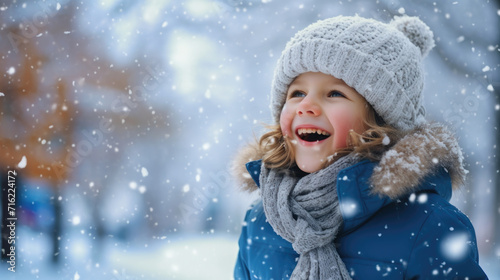 Joyful little girl laughing in snow. Perfect for winter-themed projects or advertisements
