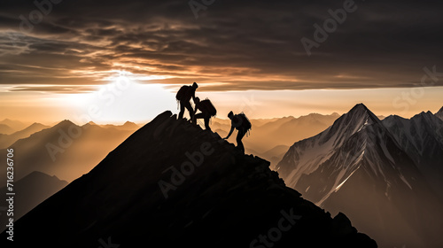 Photo of sillhouette two climbers ascending a steep mountain slo © pasakorn