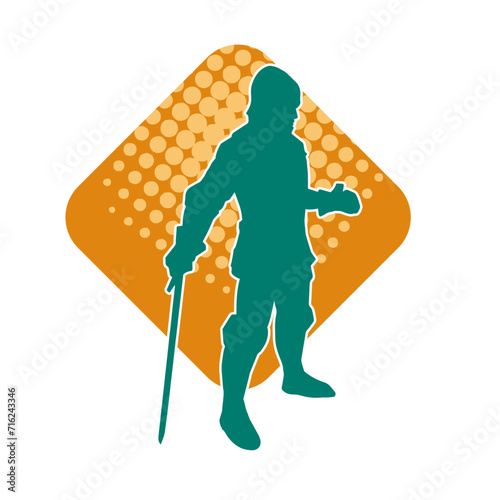 Silhouette of a male warrior wearing war armor suit in action pose using a sword weapon.