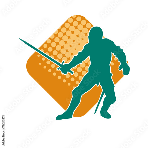 Silhouette of a male warrior wearing war armor suit in action pose using a sword weapon.