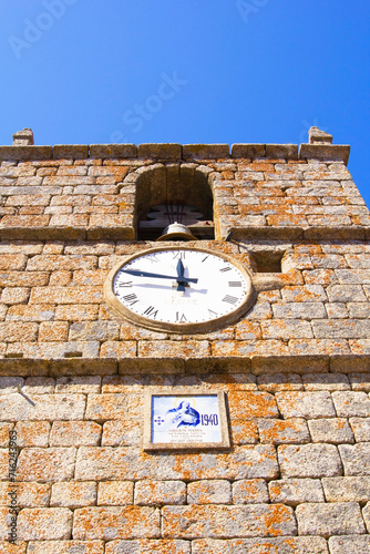 photo bottom view of the clock tower in the village of Monsanto, Portugal, Europe