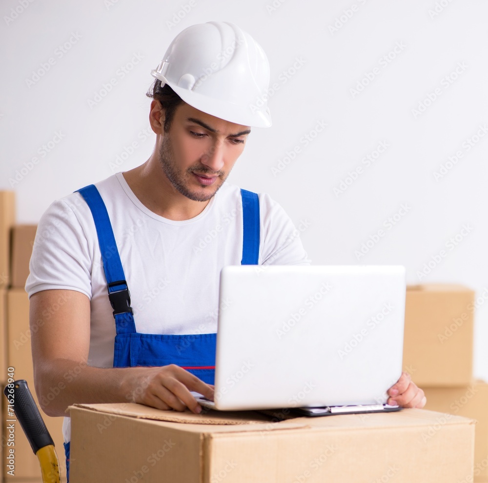 Young male professional mover doing home relocation Young male professional mover doing home relocation