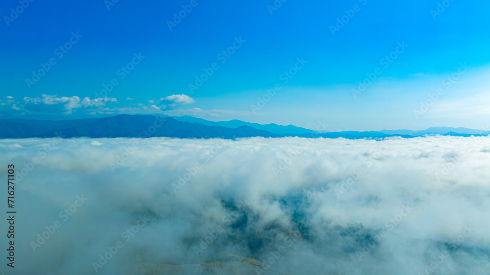 Aerial view of mountain mist clouds and mixed forest. Green deciduous tree with clouds Rich natural ecosystem, concept of nature view and environmental conservation.