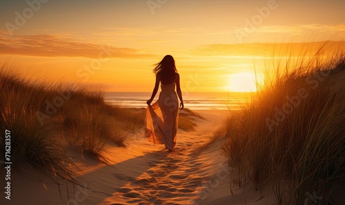 Woman Walking Along Serene Beach As Sun Sets