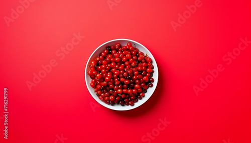 Cranberries in white bowl, isolated, red background 