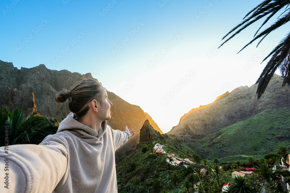 Man in White Robe Standing in Front of Tenerife Mountain