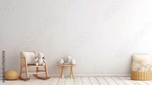 A minimalist nursery room with a rocking chair, a small table with a teddy bear and a basket on the floor. The room has a white wall and wooden floor.