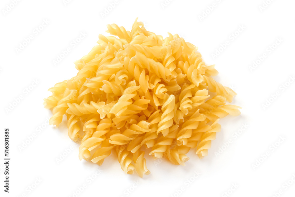 Pile of uncooked spiral pasta on a white background. Pasta isolated close-up.