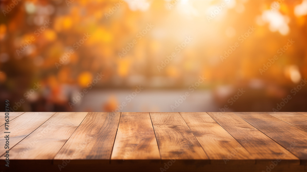 The empty wooden table top with blur background of autumn. Exuberant image. The empty wooden table top with blur background of autumn. Exuberant image.