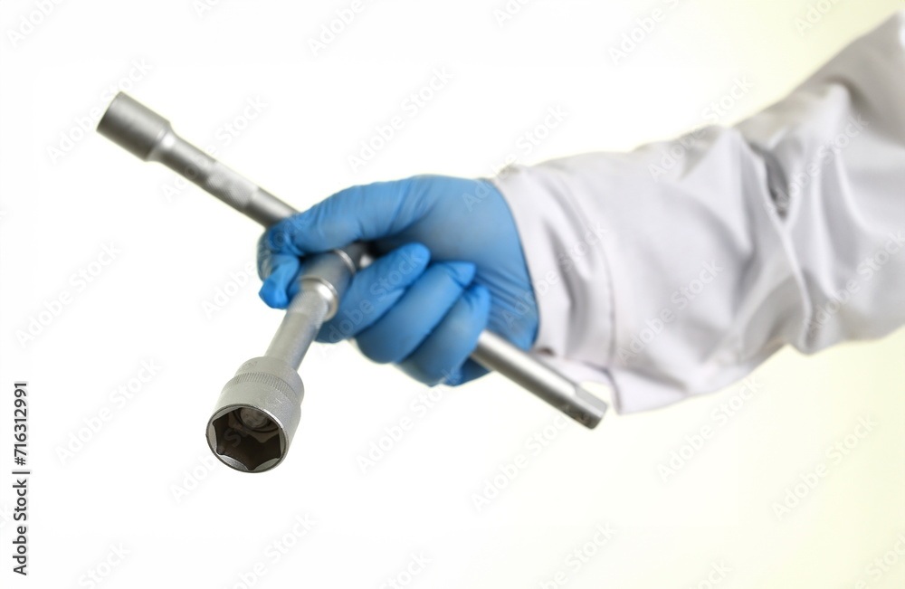 The key for the car repair man holding in his hand. Isolated on white. The key for the car repair man holding in his hand. Isolated on white.