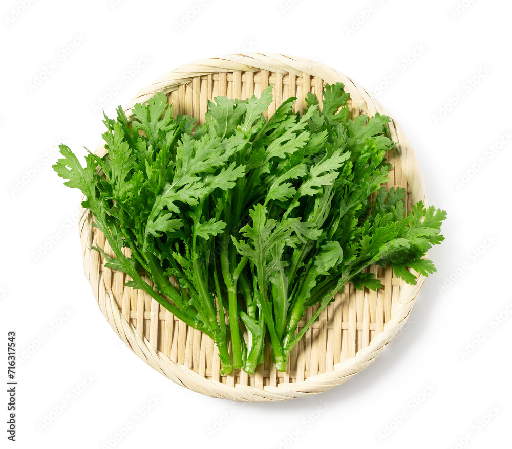 Garland chrysanthemum placed against a white background. Garland chrysanthemum is an Asian vegetable. Garland chrysanthemum placed against a white background. Garland chrysanthemum is an Asian vegetable.